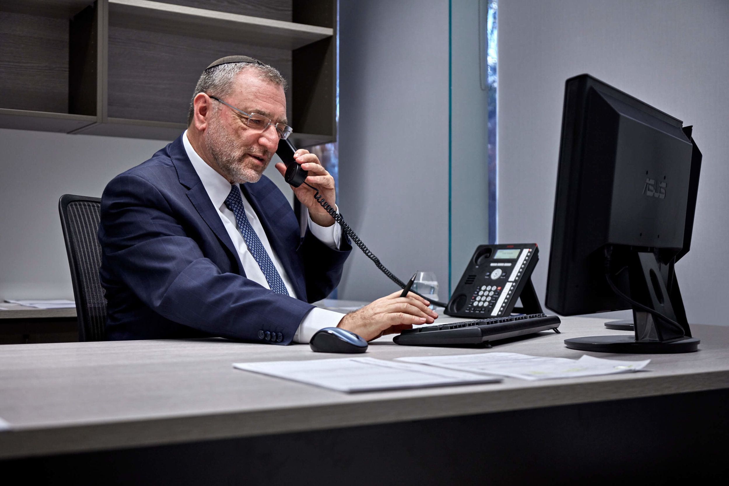 Robert Lebovits, director of Green & Sternfeld, on the phone at his desk