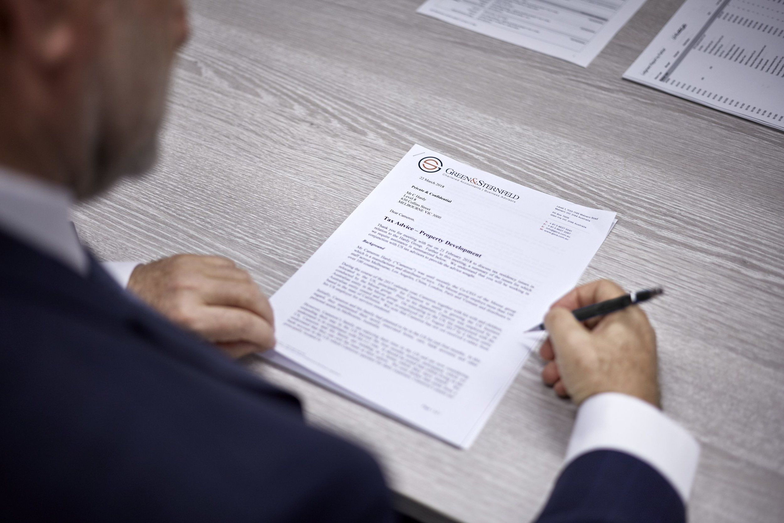 Robert Lebovits signing a document