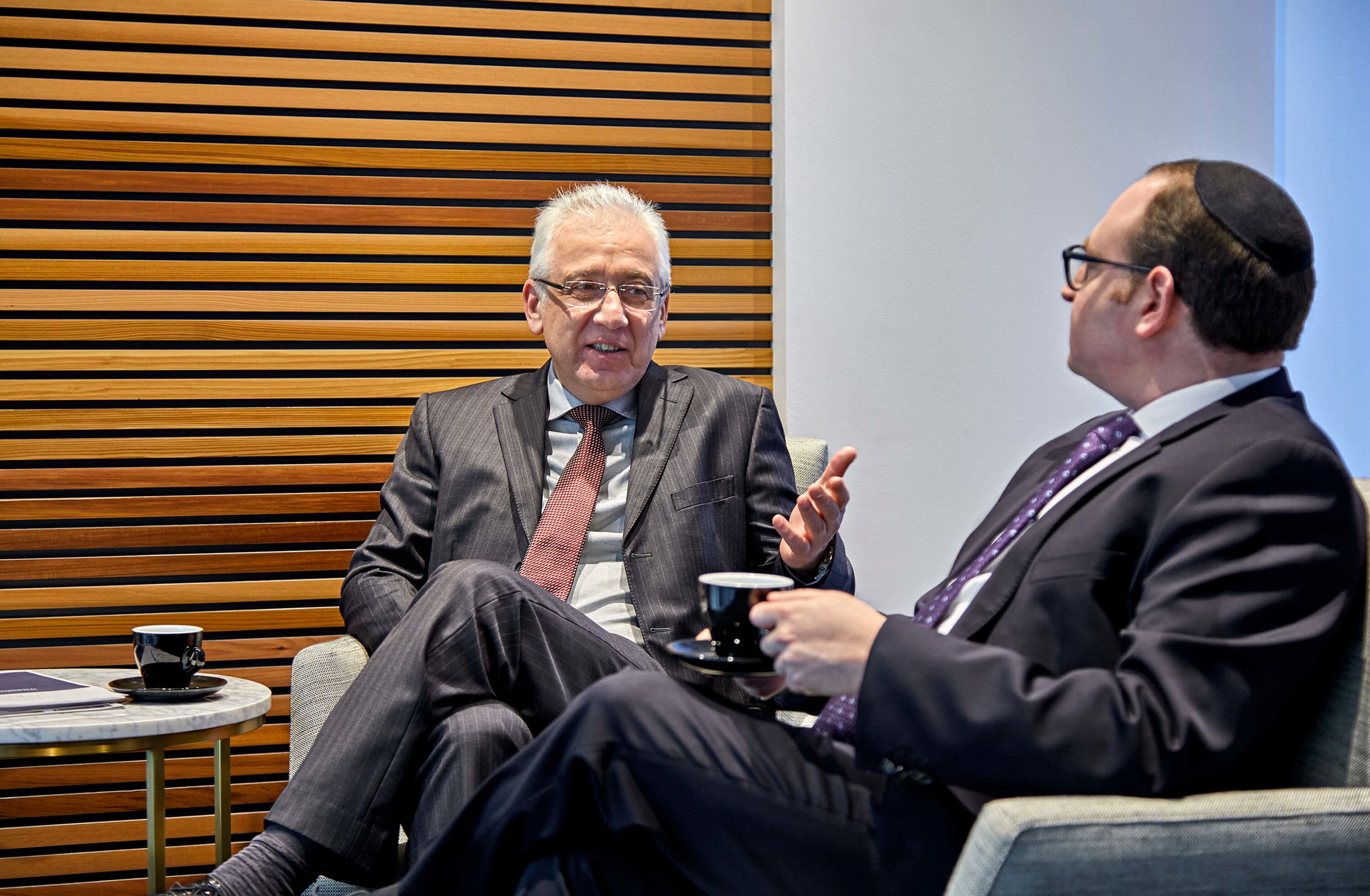 Leon Vilshansky and Eli Lebovits seated in the Green & Sternfeld reception